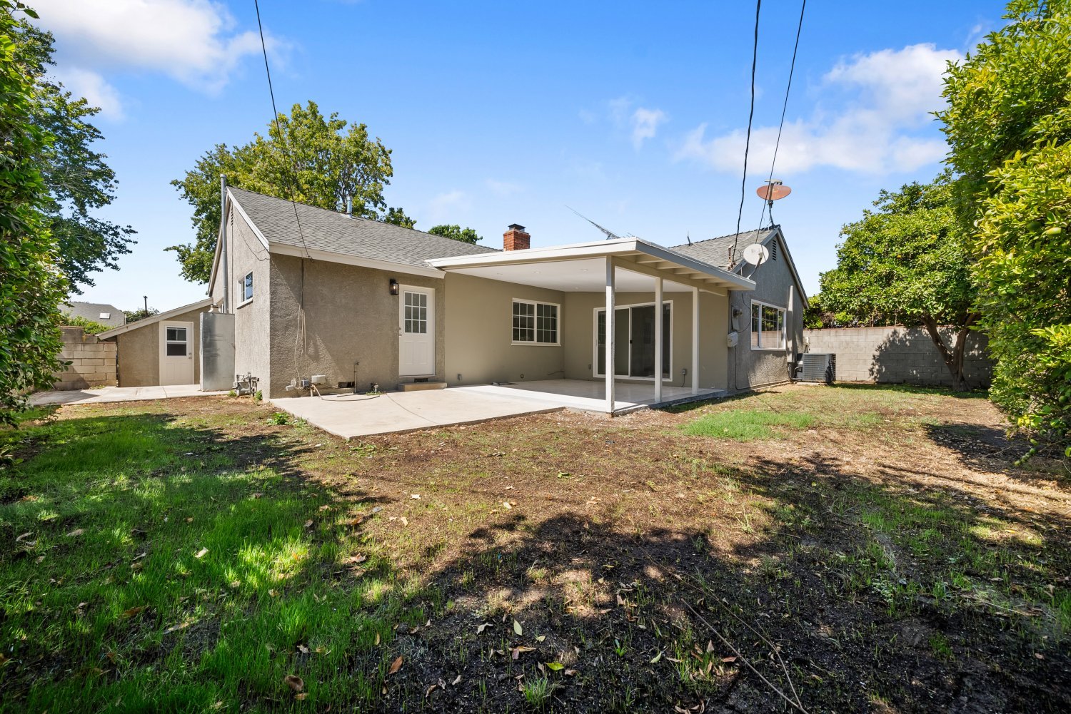 backyard of los angeles home with mix or dirt and grass patches available for sale at 7014 Colbath Ave