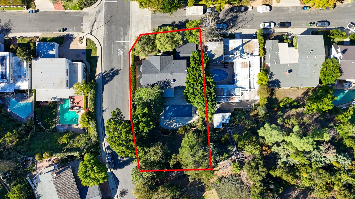 exterior overhead drone shot of 3136 Dona Sofia Dr Studio City, CA with red line outlining the lot